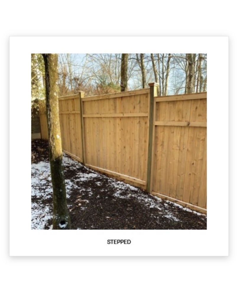 Stepped wood privacy fence on uneven terrain