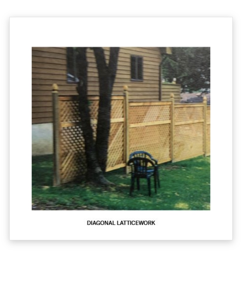Diagonal lattice wood fence beside a home